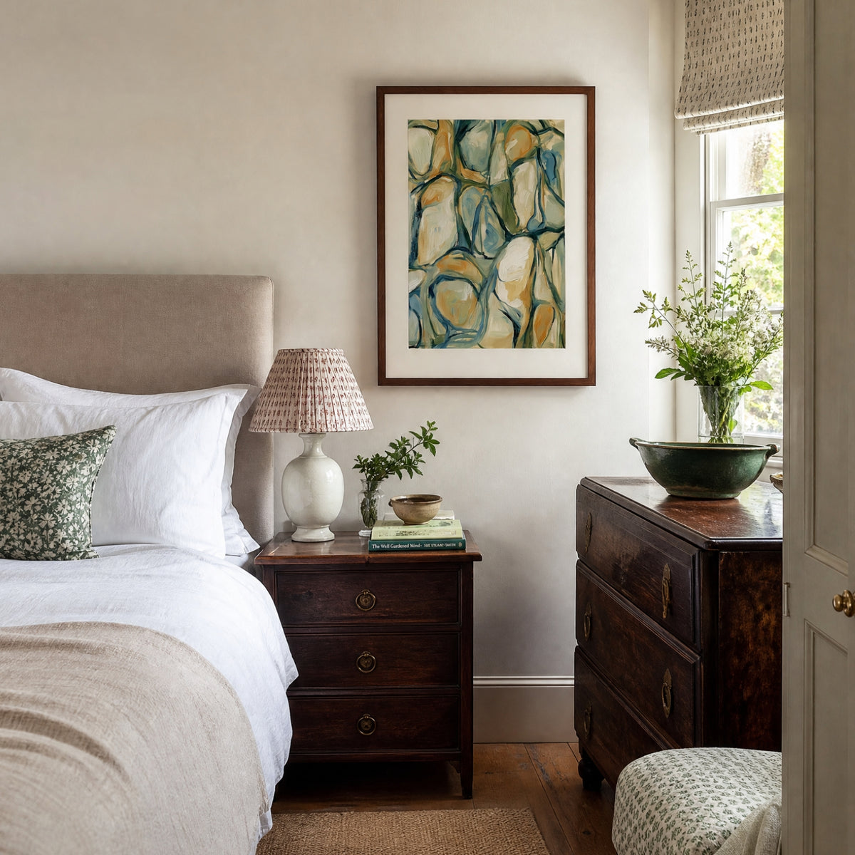 Abstract art print displayed above an antique bedside table
