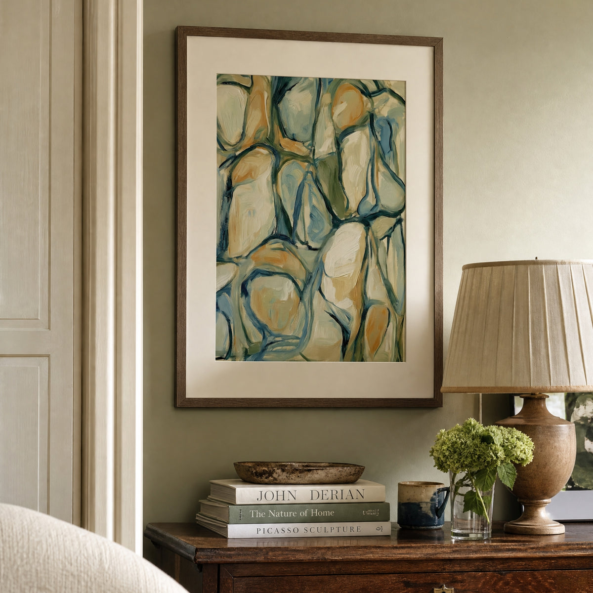 Abstract art print displayed above an antique sideboard
