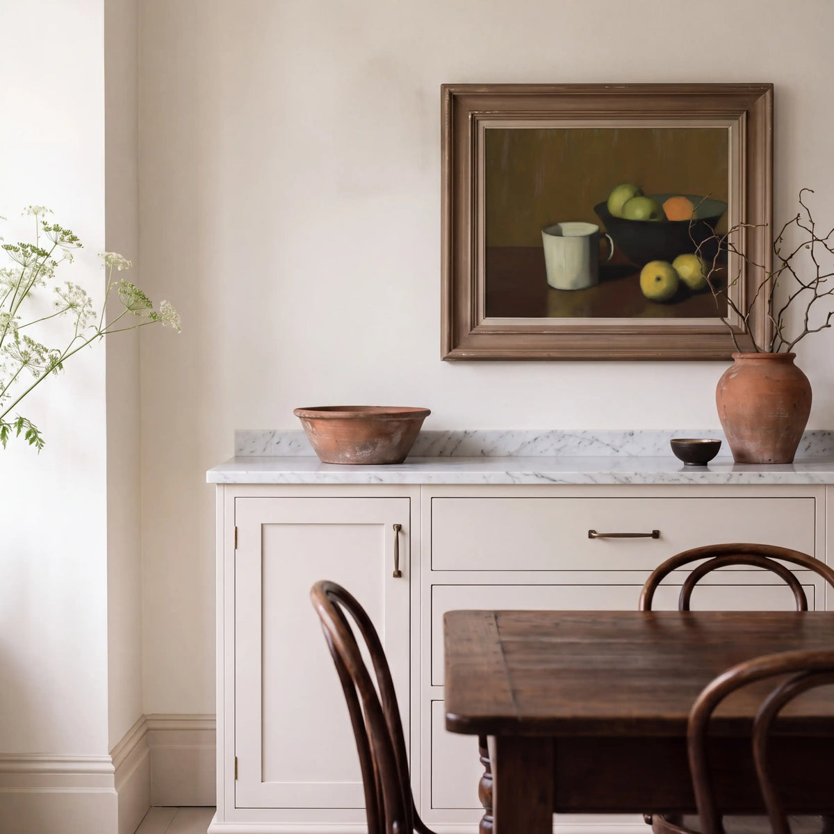 Still life art print displayed in a traditional kitchen